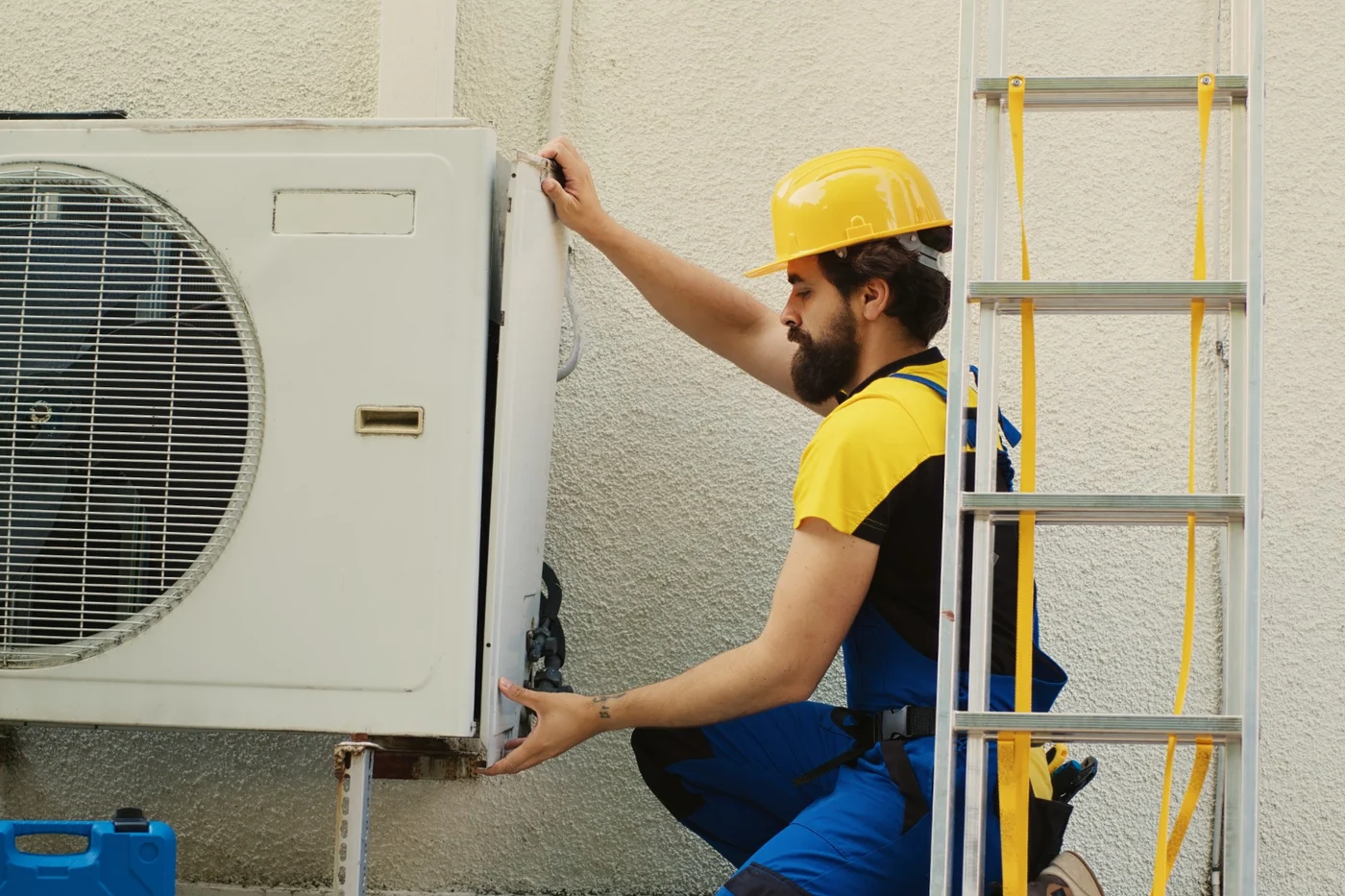 Air-conditioner isolator and electrical repair services in Gauteng Electrician disassembling an air-conditioner during electrical repair work