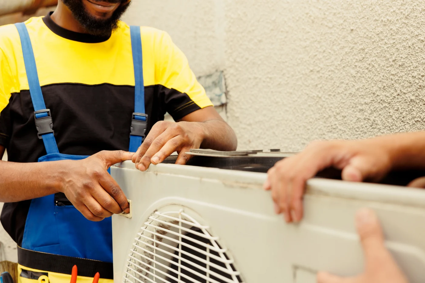 Air-conditioning electrical inspection maintenance and COC correction support in Gauteng Technician inspecting and servicing an outdoor air-conditioning unit