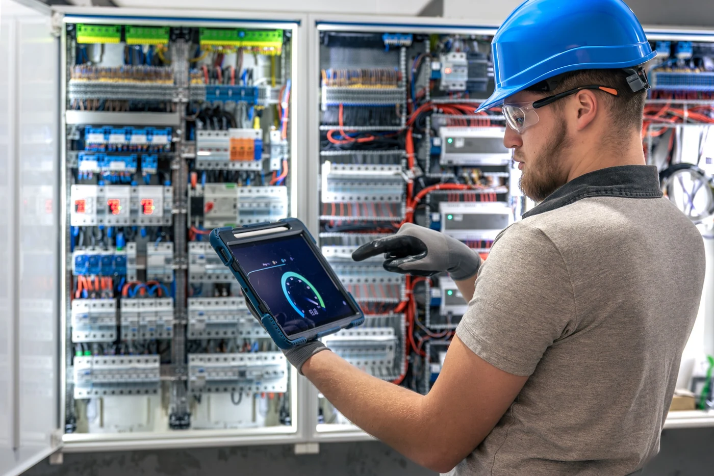 Electrician checking DB board control equipment during repair and upgrade work