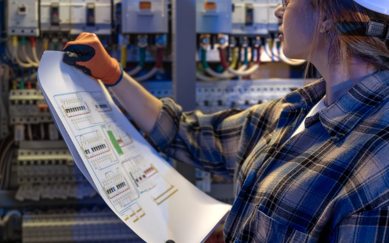 Electrical switchgear inspection and maintenance audit in Gauteng Electrician comparing electrical schematics with switchgear during a maintenance audit