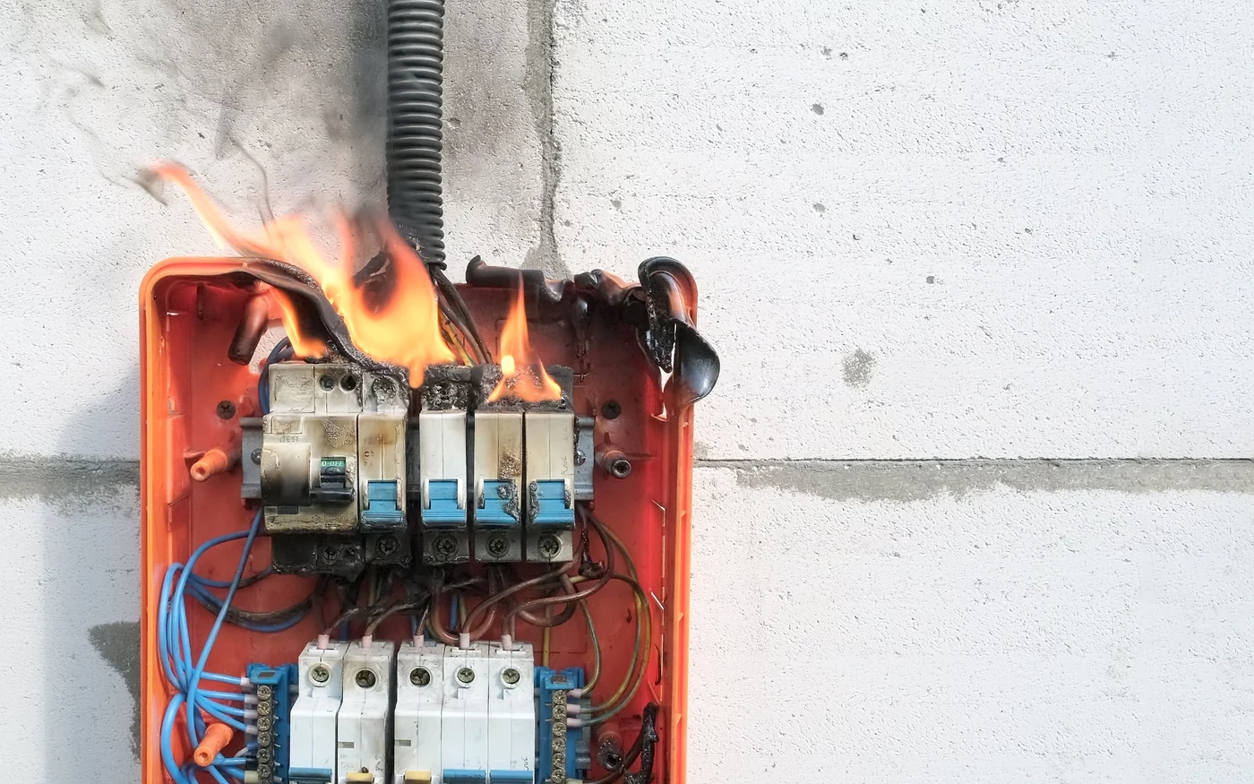 Burning electrical distribution board showing a serious electrical fire and overheating warning