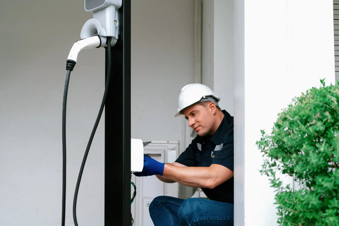 Electrician connecting and testing the electrical supply for a home EV charger