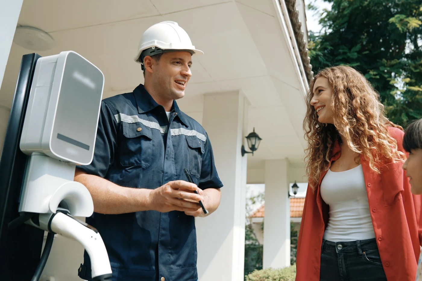 EV charger electrician explaining a home charger installation to a customer