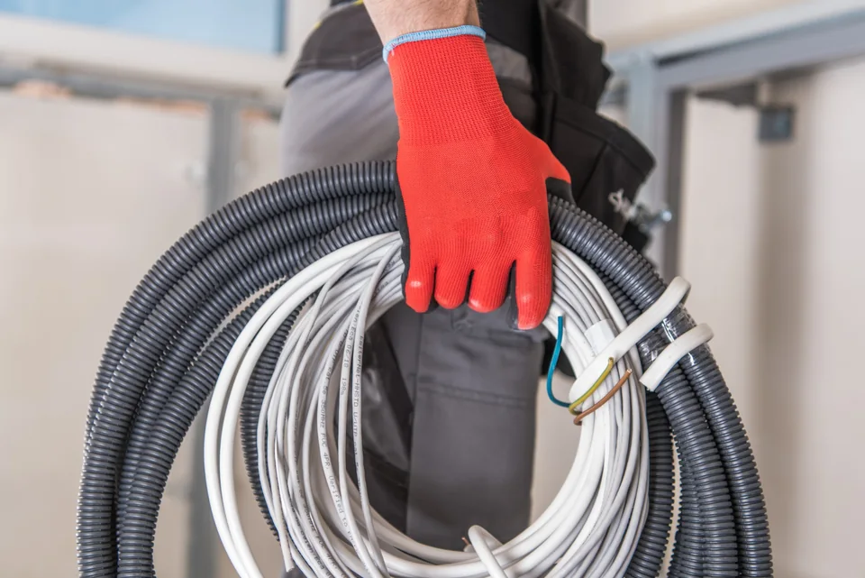 Electrician carrying electrical cables for installation work