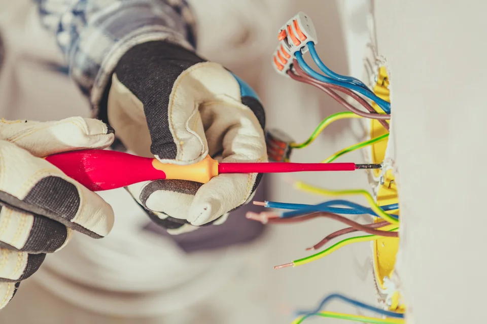 Electrician wiring an electrical outlet during installation work