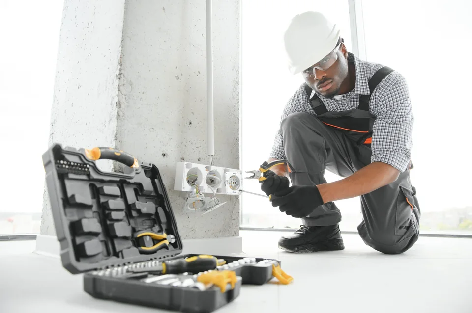 Registered electrician replacing a plug socket and checking wiring