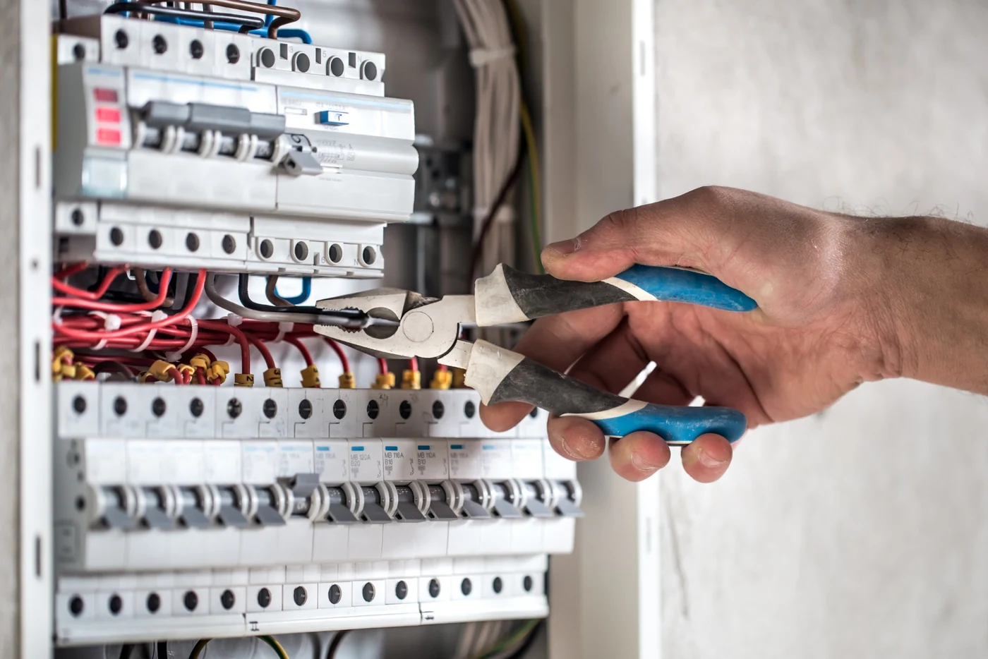 Electrician working on DB board wiring and circuit protection