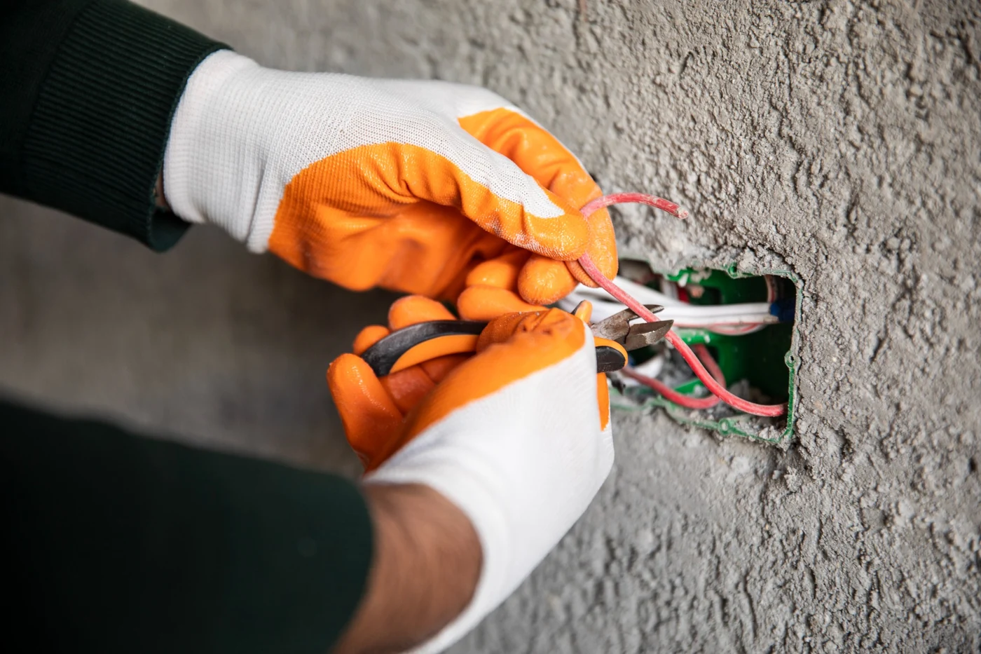 Electrician preparing electrical wires for a plug point connection