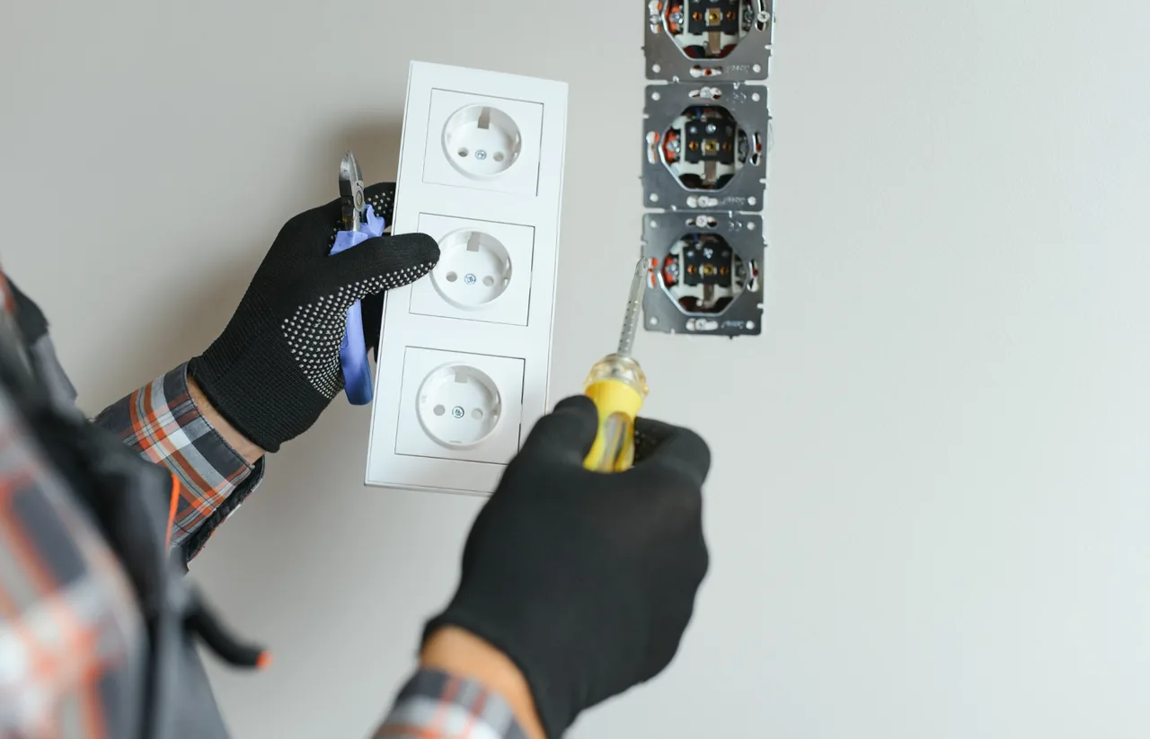 Residential plug point installation and socket repairs in Gauteng Residential electrician replacing plug points and electrical sockets in a home