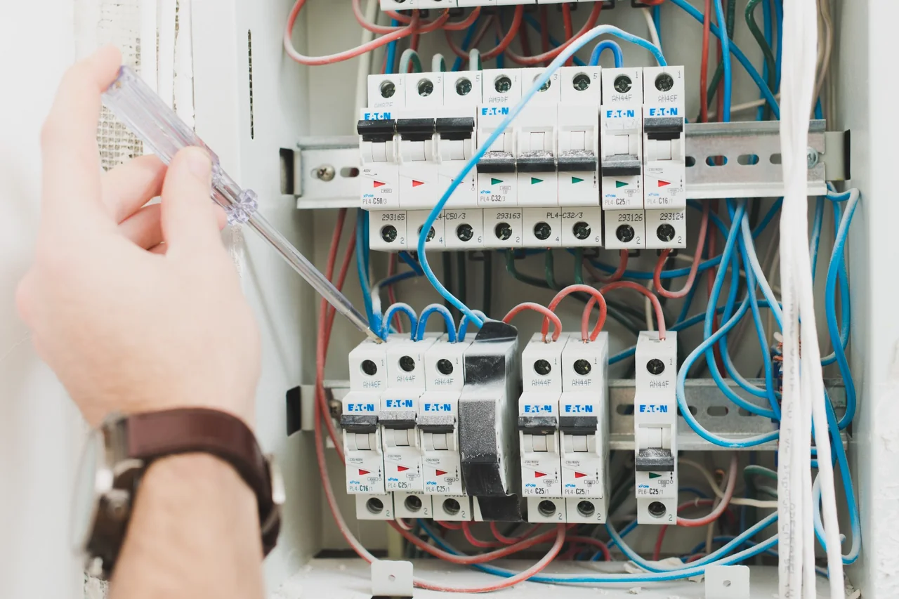 Residential electrical maintenance and DB board checks in Gauteng Electrician carrying out residential electrical maintenance inside a home distribution board