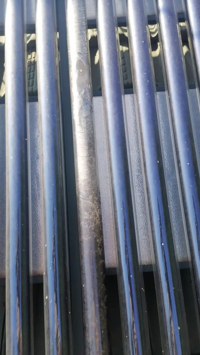 100 Litre Evacuated Tube Solar Geyser Conversion – Why Homeowners Trust Our Solar Geyser Plumbers close view of evacuated solar tubes inspected by trusted solar geyser plumbers
